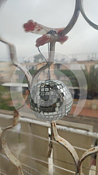 round shiny mirror ball hanging on the window, objects