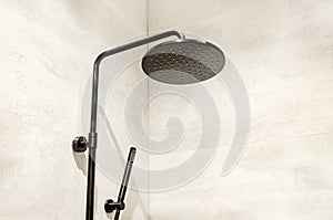 round shower head in shower cabin on background of gray ceramic tiles. shower column with rain shower