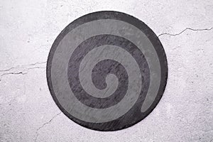 Round slate stand on a gray background