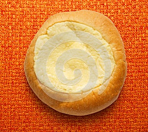 Round sour cream dessert bun photo