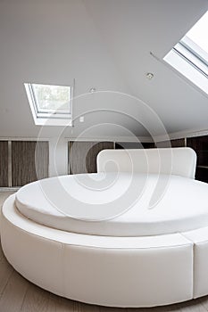 Round spacious bed in designed house