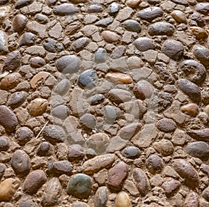 round sparse colorful stones among brown flat ones background