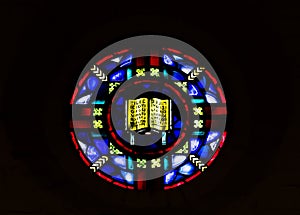 Round Stain Glass Window Against Dark Background