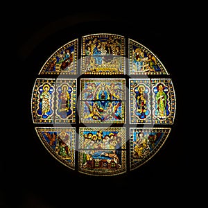 Round stained glass window depicting saints