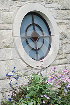 A round stained glass window at Ewing and Muriel Kauffman Memorial Garden