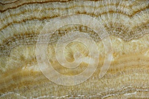 Round stains on a slab of a natural stone Onyx, horizontal background