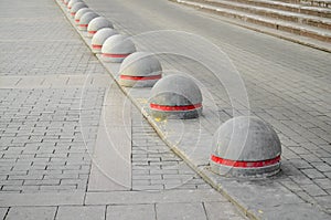 Round stone road kerb.
