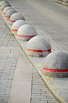 Round stone road kerb.