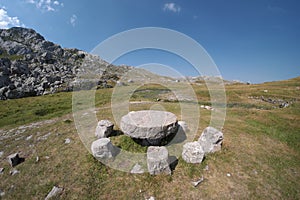 Round Stone Table And Stone Seats On Meadow photo