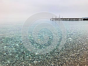 Round stones and clear sea with some very small waves