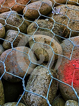 Round stones laid in gabion