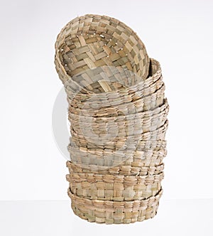 round straw craft basket on white background