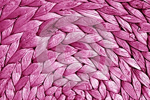 Round straw mat texture in pink tone.