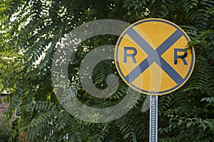 Round Street sign symbol with X and two R\'s yellow gold and black