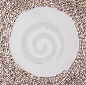 Round stylish metal frame on a white marble background. Card with copy space for text