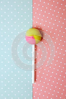 Round sweet candy on a stick. On colored backgrounds