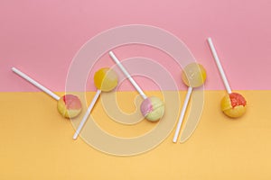 Round sweet candy on a stick. On colored backgrounds