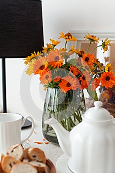 Round table for morning fresh tea with tablecloth and flowers