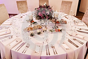 Round table set with floral centerpiece for wedding reception