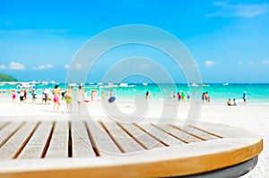 Round table top on blur beach background with people