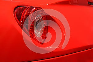 Round taillight on a red sport car.