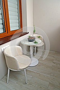 Round tea table and two chair chairs on the loggia