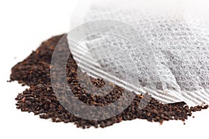 Round teabag on tea leaves.