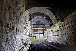 Round tiled tunnel in abandoned underground nuclear physics laboratory