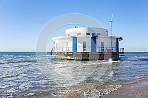 Round tourist lighthouse restaurant in the sea on a sunny day. Peace and relaxation