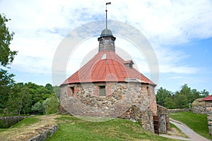 Round tower of Lars Torstennson in the ancient Korela fortress in the cloudy June afternoon. Priozersk, Russia