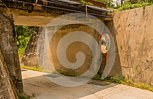 Round traffic mirror beside rural underpass