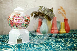 Round transparent bubble vending candy machine toy on a colorful background