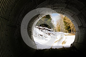 Round tunnel for cars, pedestrians and skiers in a ski resort.