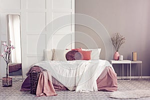 Round velvet pillow on king size bed with cozy bedding