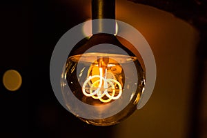 Round vintage lightbulb with glowing wire