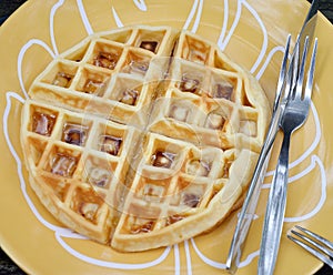 Round waffle with syrup on dish