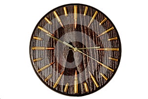 Round wall clock made of solid wood with cartridges and bullets in a circle in military style isolated on a white background