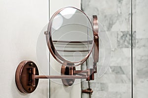 Round wall mirror for the bathroom. Photo Close-up