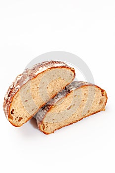 Round wheat bread with cheese inside cut in half on white background