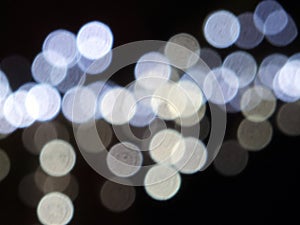 Round white bright and blue blurred restive lights on black photo