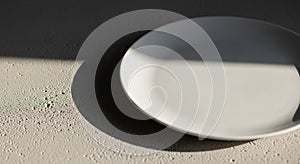 Round white ceramic plate sits on