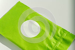 Round white sticker on green poly mailer envelope photo