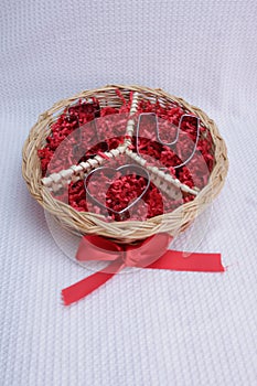 round wicker basket with peace logo symbol, red ribbon, I Heart love u cookie cutters