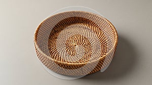 Wicker basket with tightly woven pattern featuring a flat base