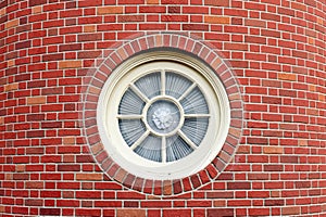 Round window in brick tower