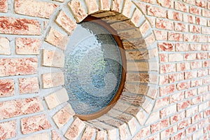 Round window on brick wall - shallow depth of field - focus on t