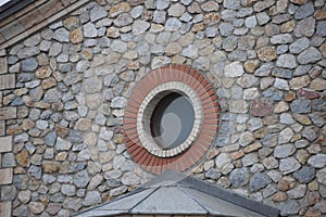 Round window on a stone wall of church