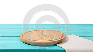 Round wood pizza cutting board and tablecloth on blue wooden table isolated on white background. Top view and copy space, Empty
