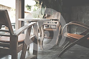 round wood table & chair in living room on mezzanine near window