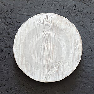 Round wooden plate on old wooden background